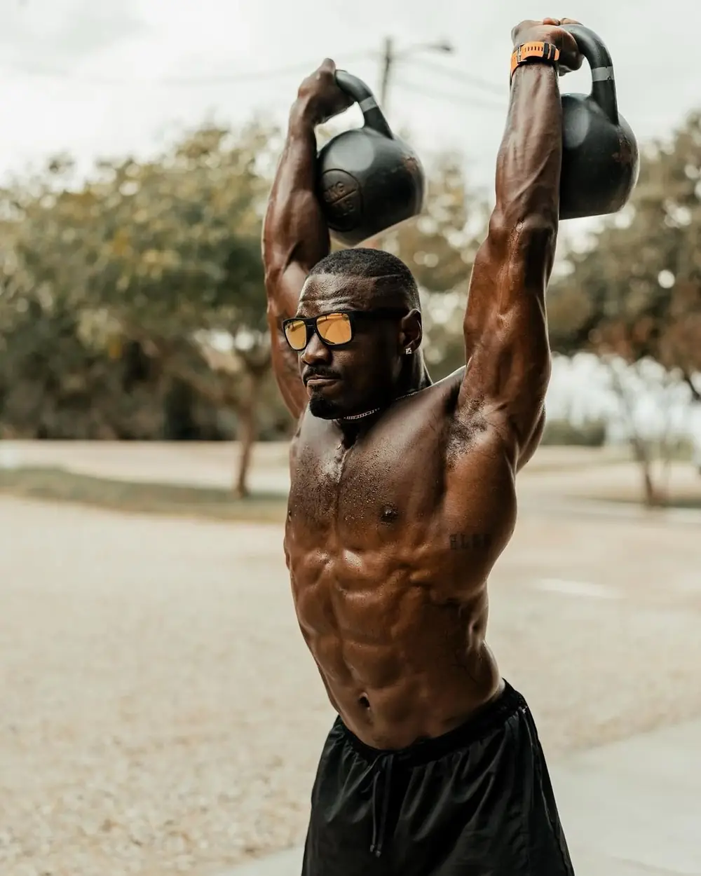 Kettlebells held overhead outdoors